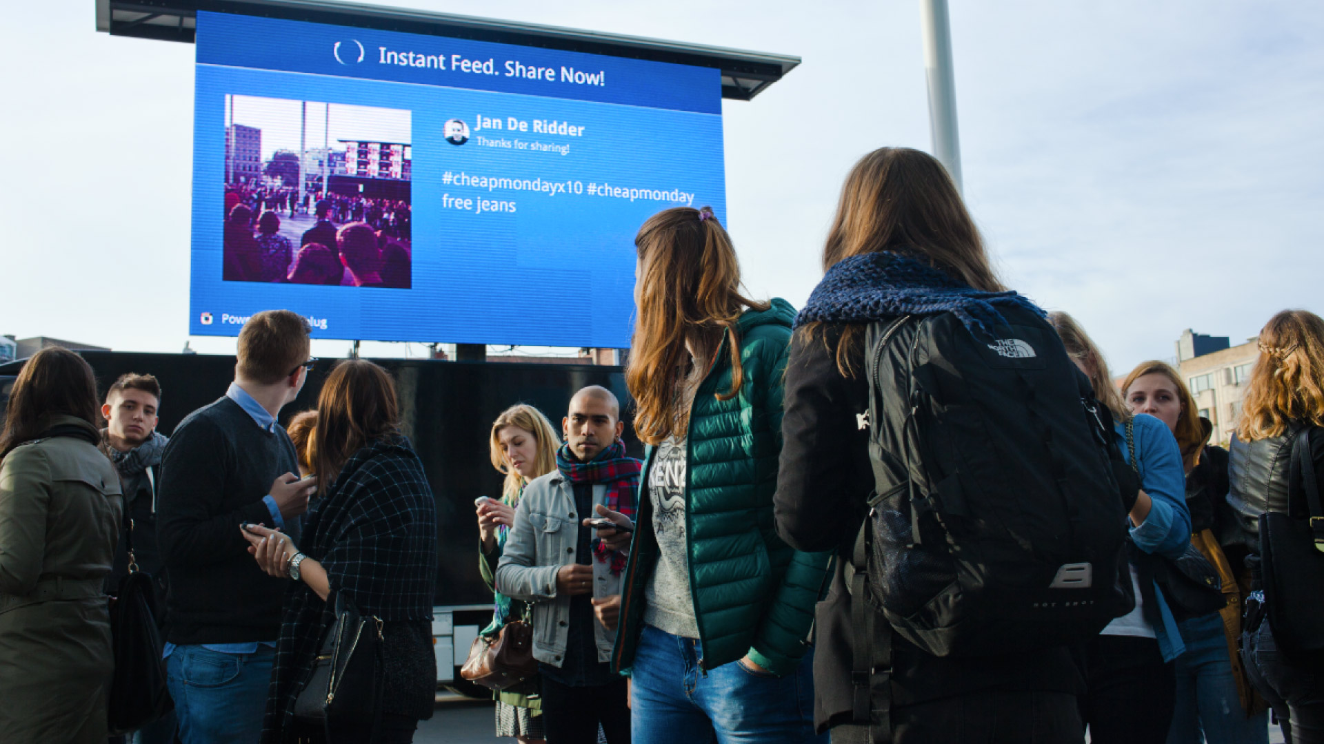 group watching large screen outdoors