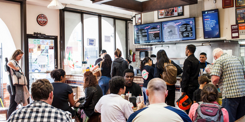 busy restaurant with digital display menus