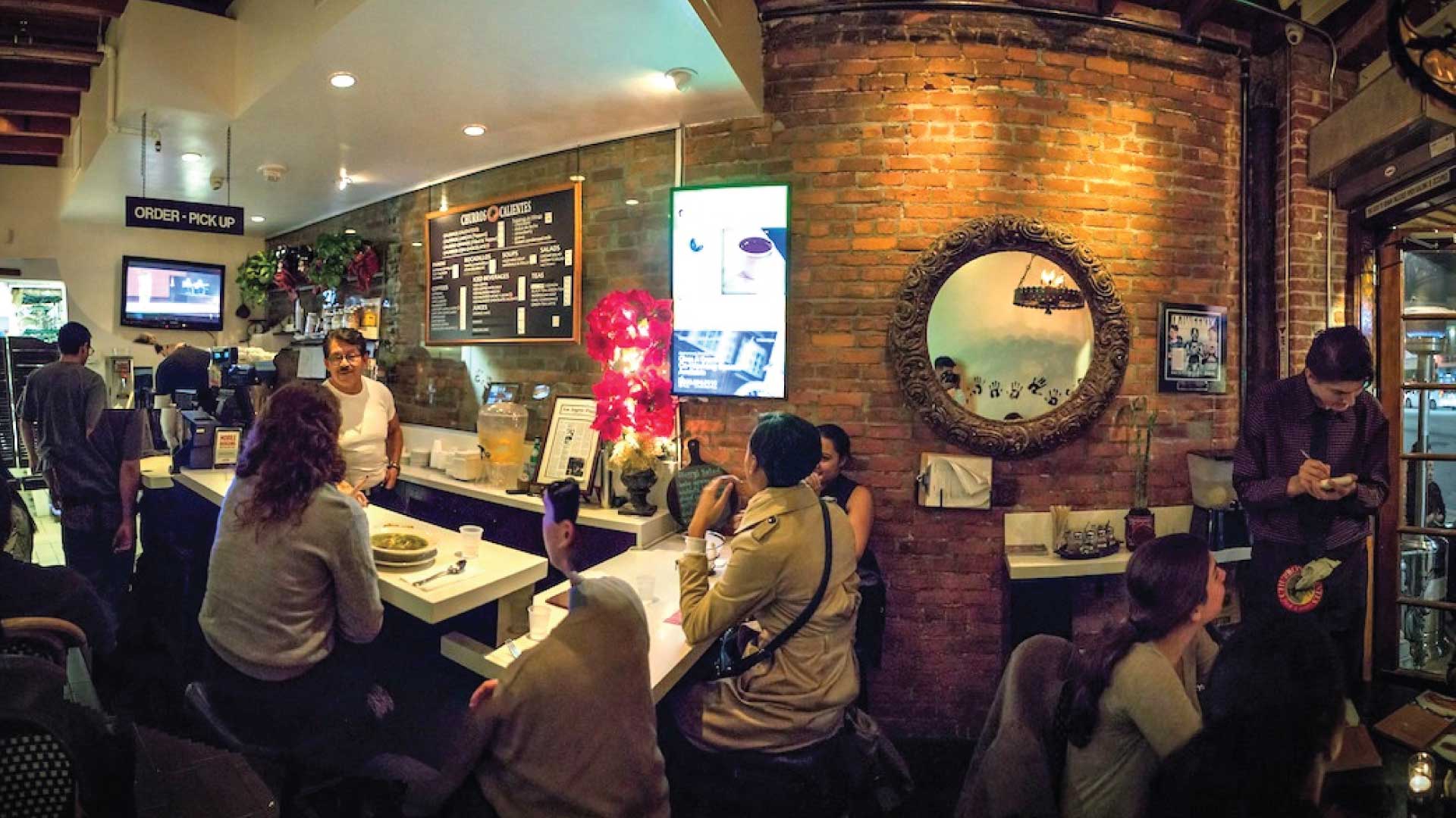 people gather at a restaurant bar