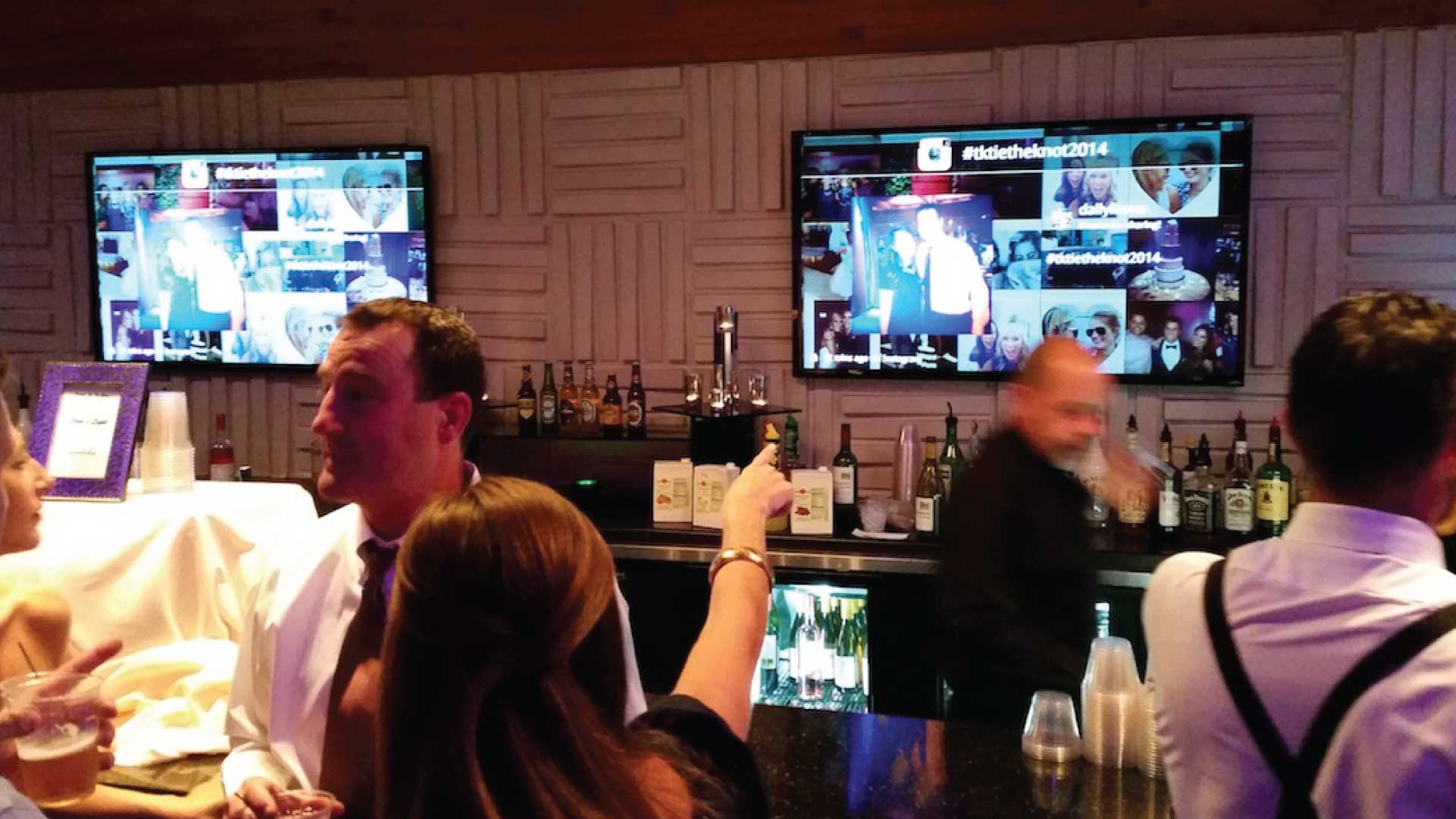 digital displays behind a busy bar