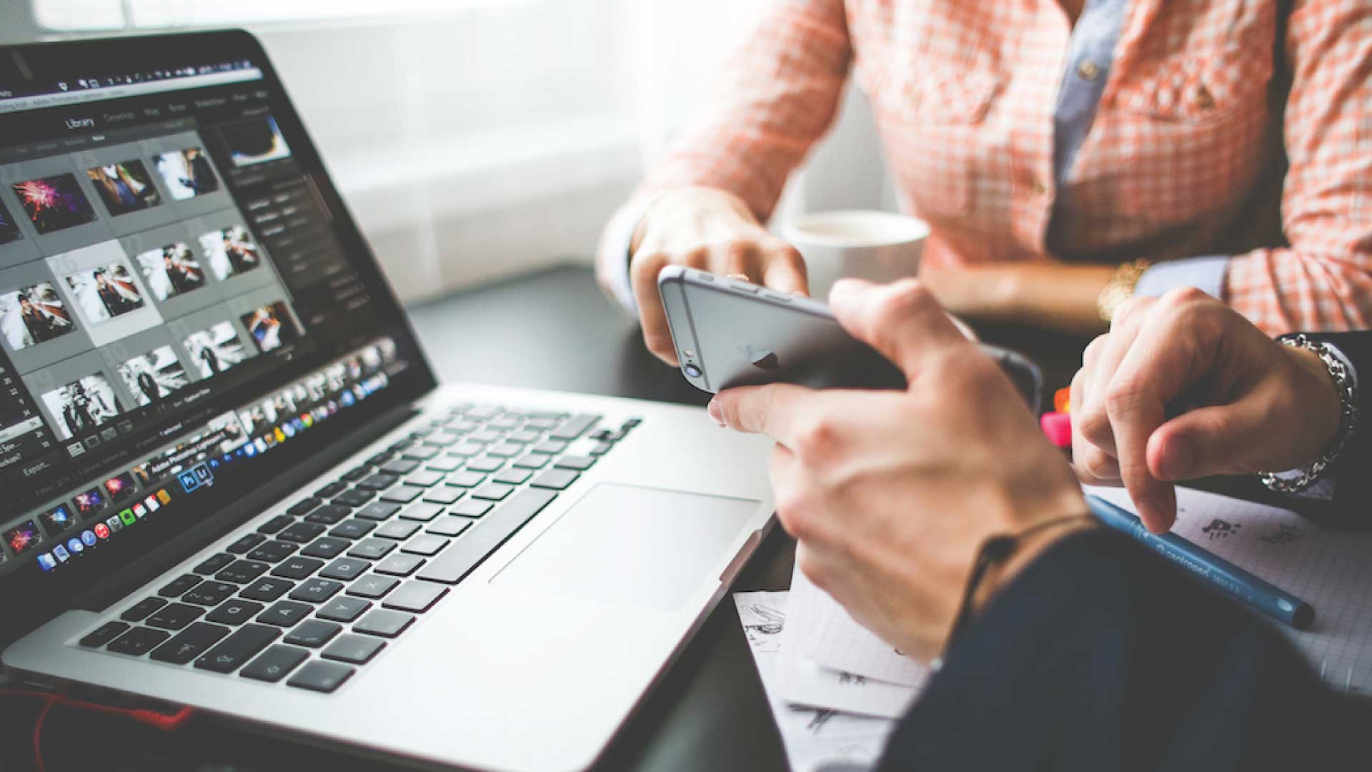 two people working over a computer