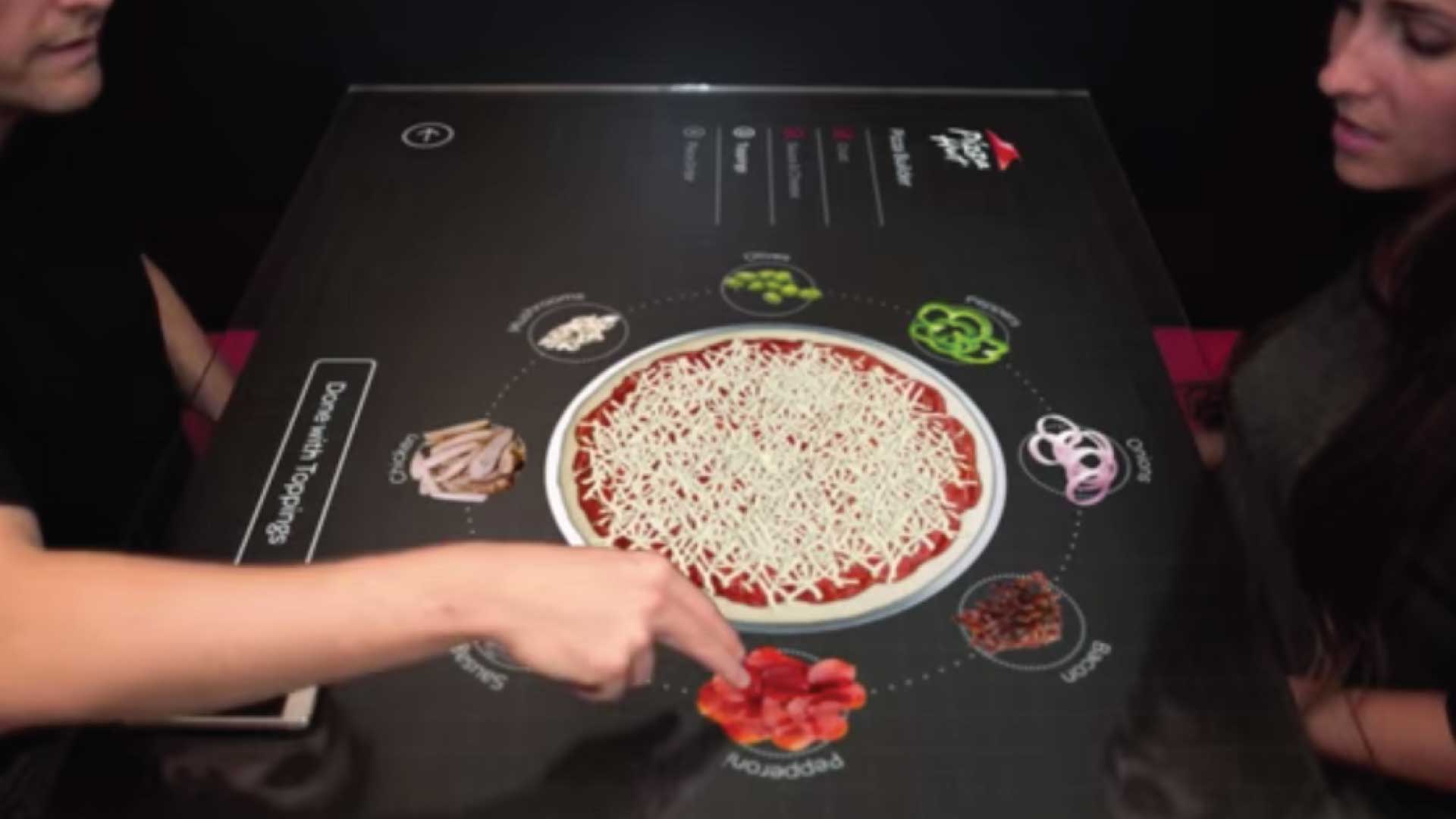 two people using a digital display table