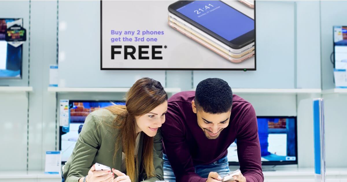 couple looking at phone at a store