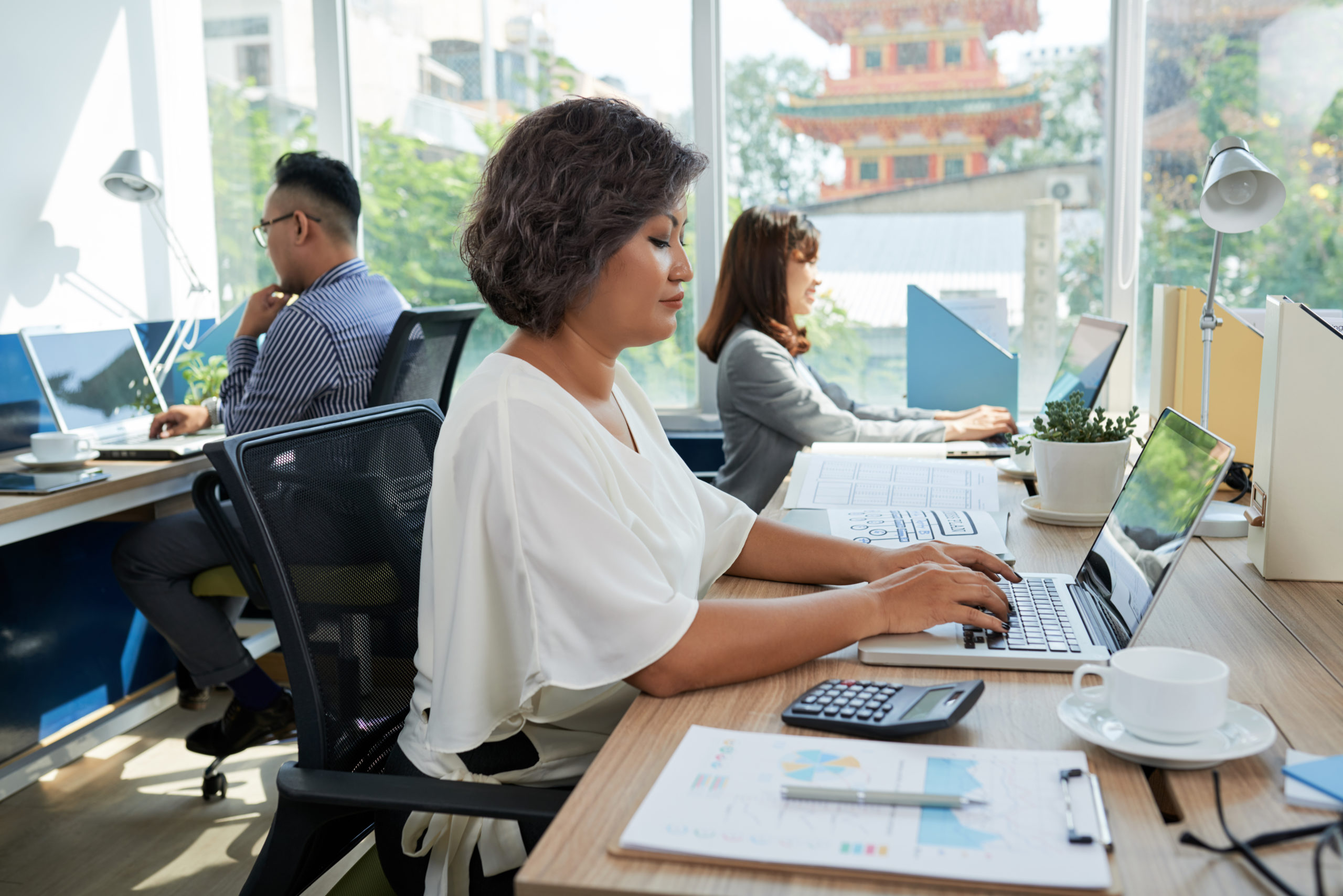 people working at desks at a coop space