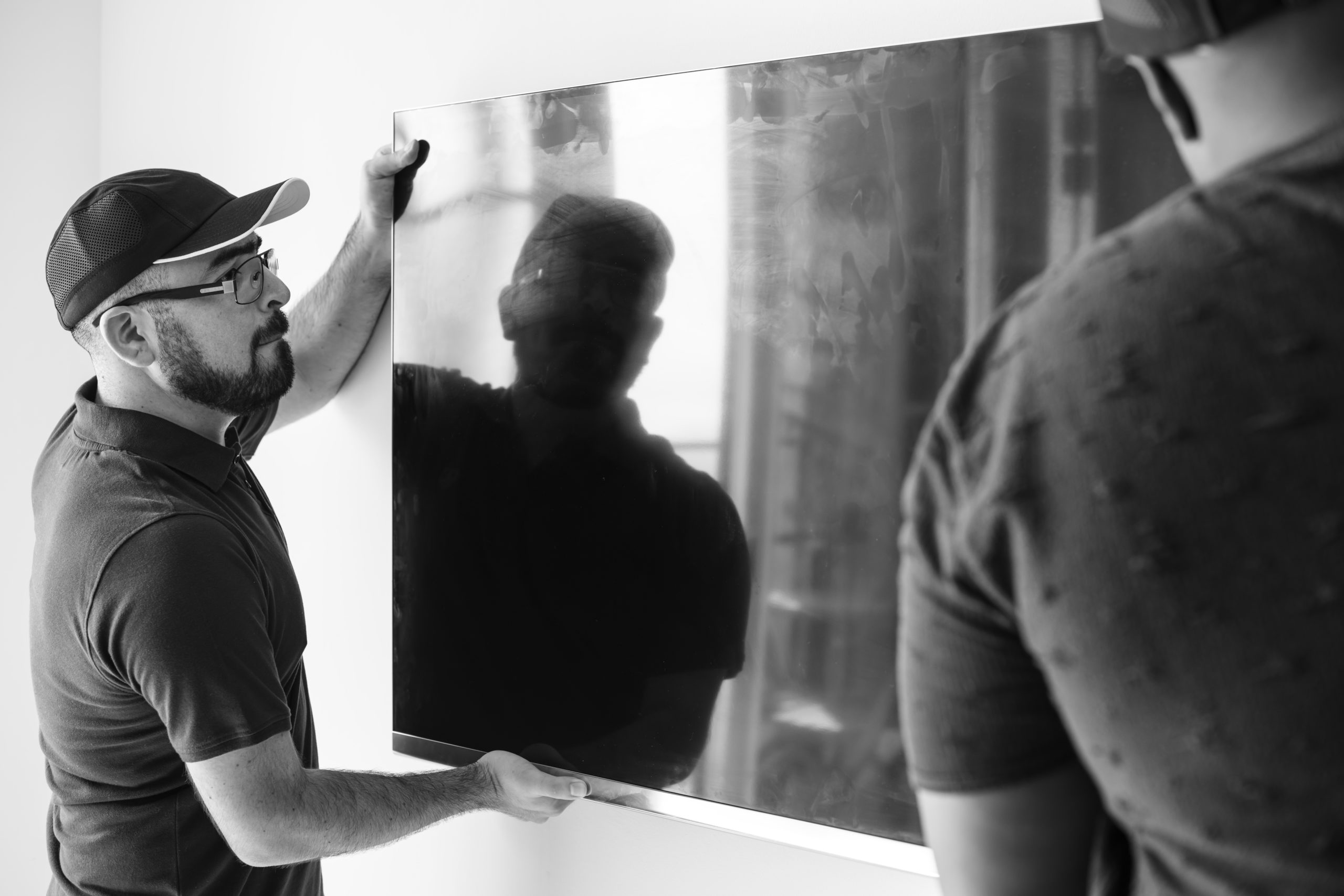 two men hanging a display