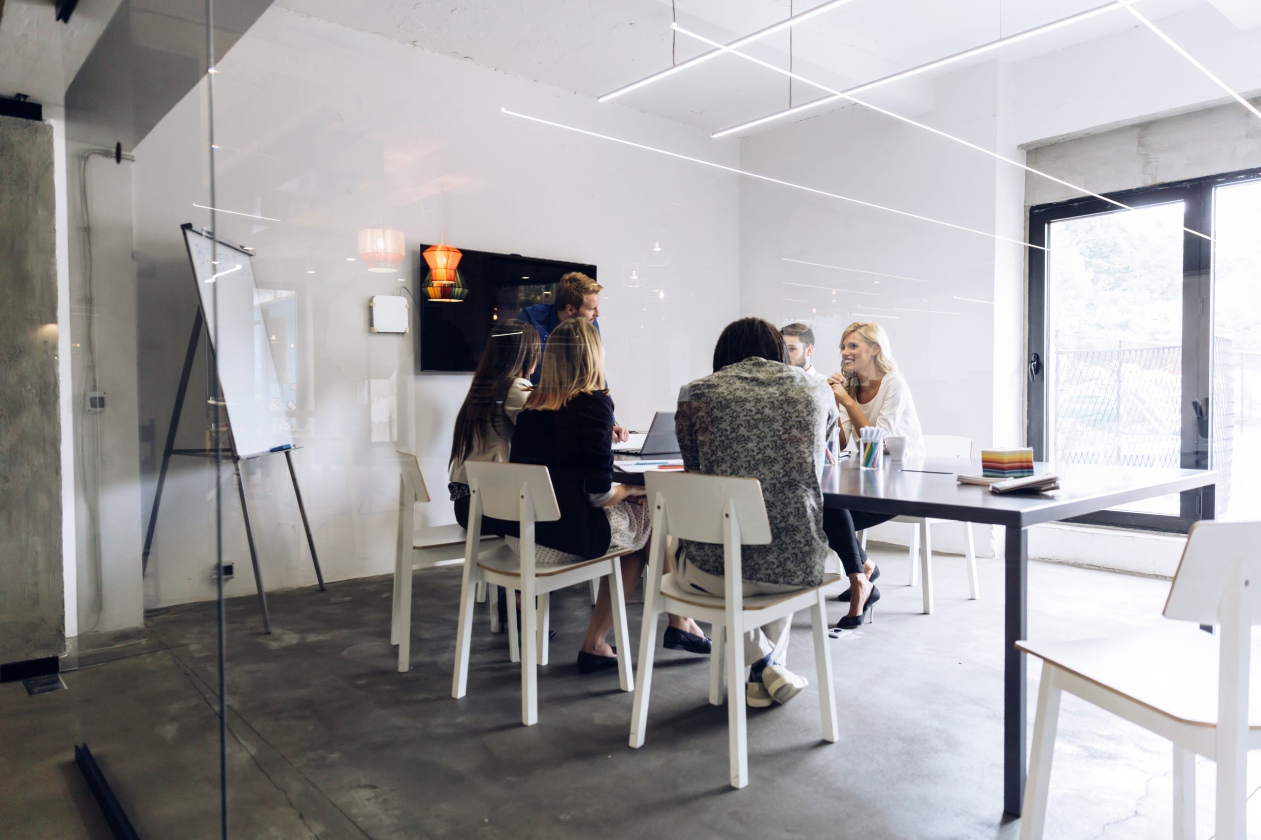 workers in an office with a wall display