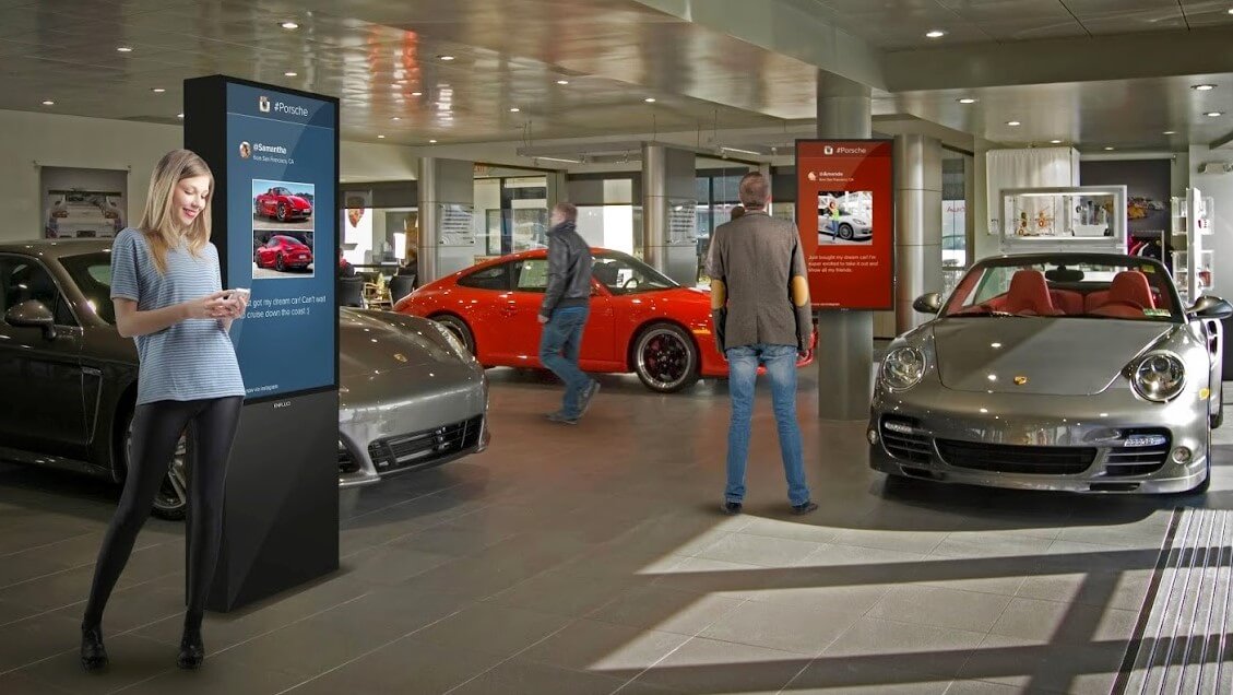 interior of an upscale car dealership with digital sign stands