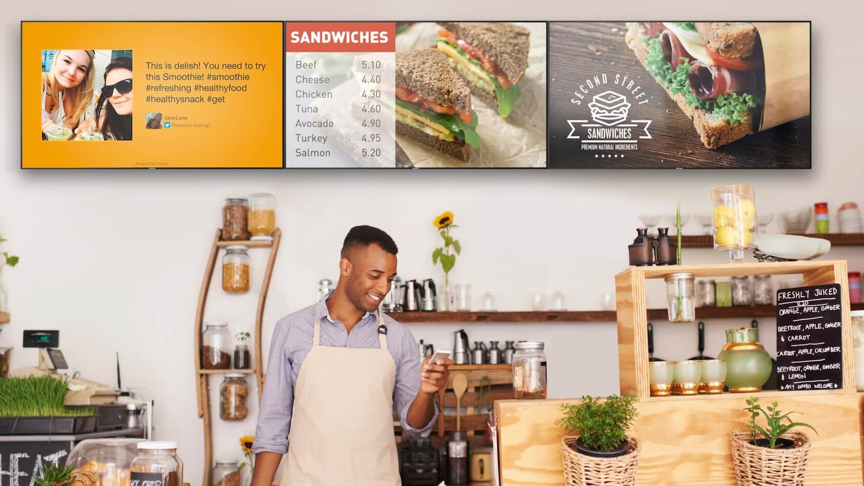 man working at a cafe looking at his phone