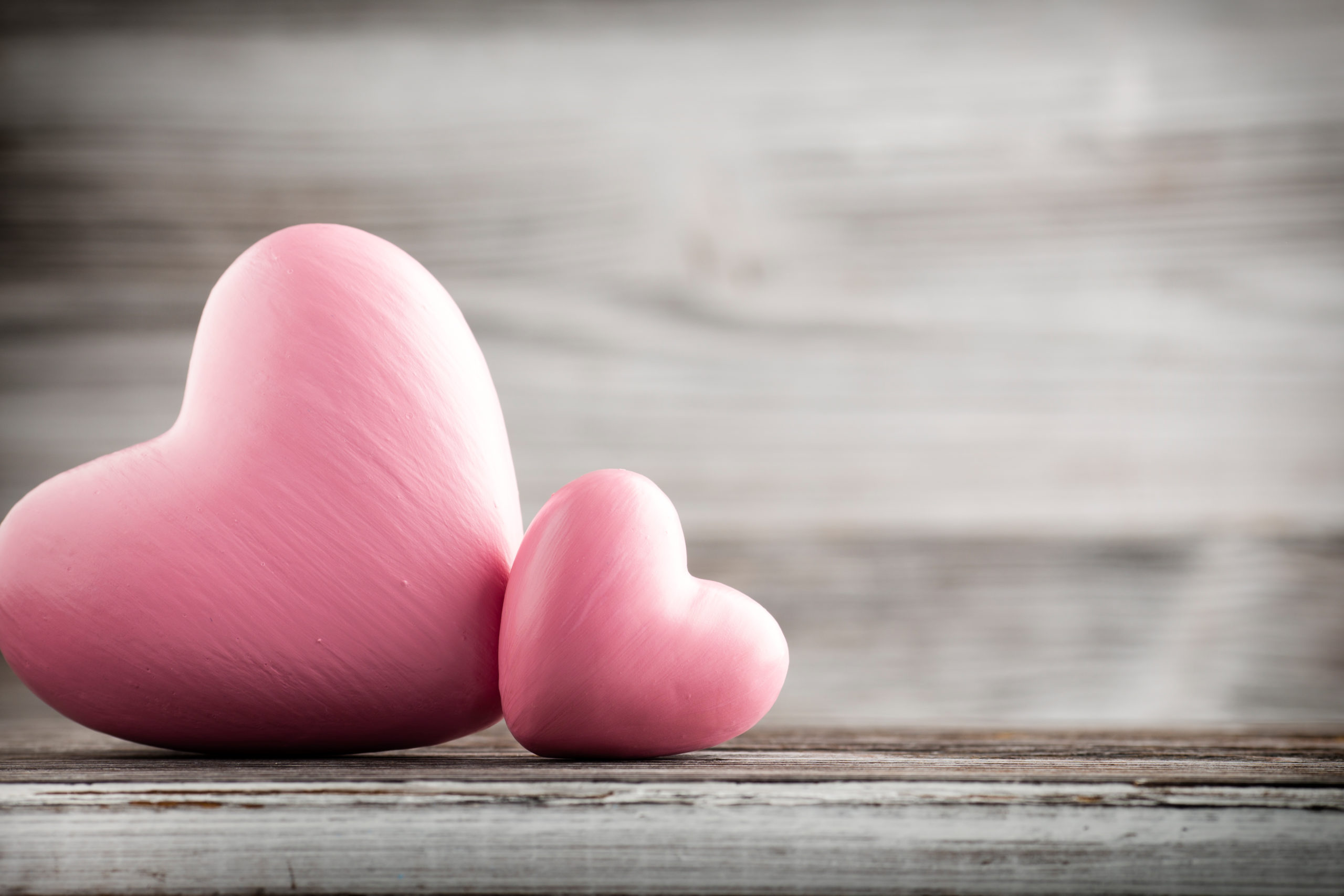 two pink hearts next to each other on a table