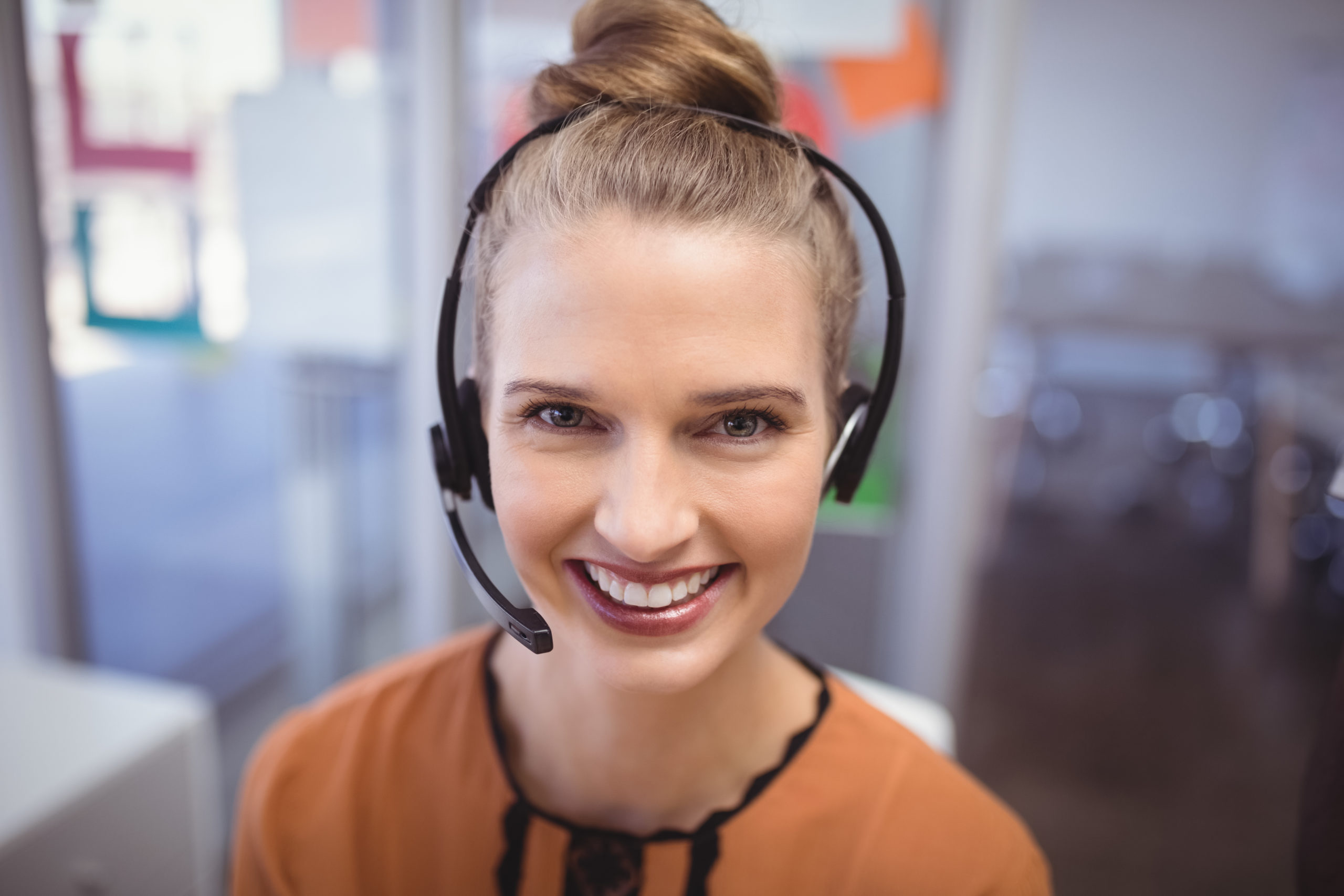 woman smiling with telephone headset on