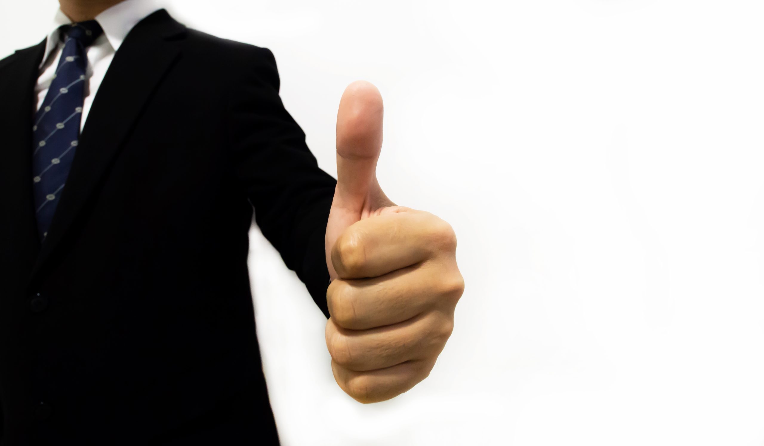 thumbs up gesture from a man in suit