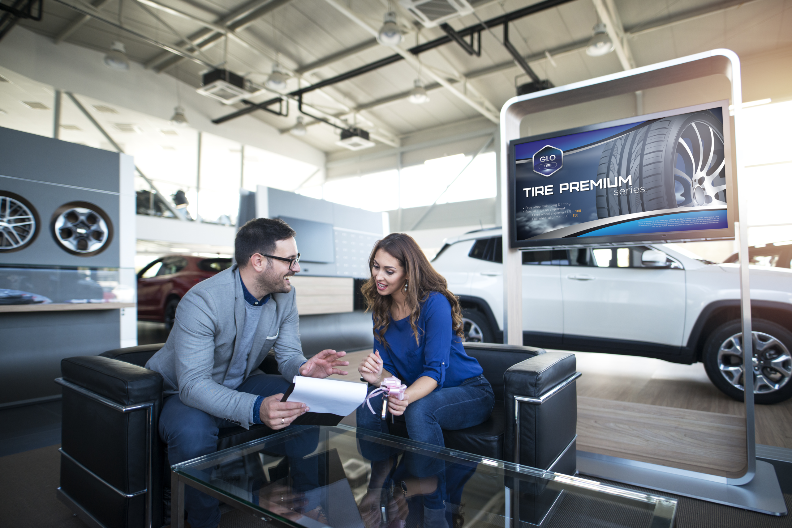 Talking at auto dealership with a digital sign behind