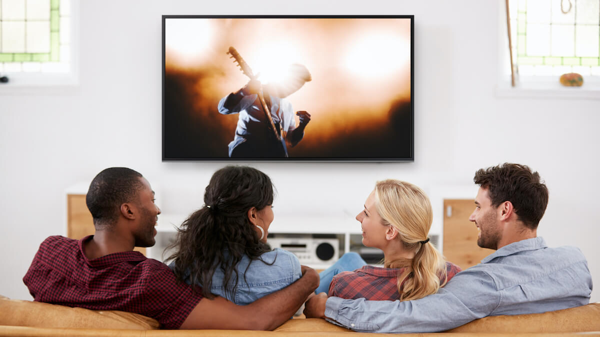 four friends on a couch watching television