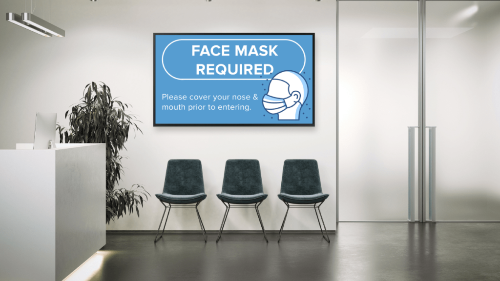 waiting room with digital display noting that face masks are required