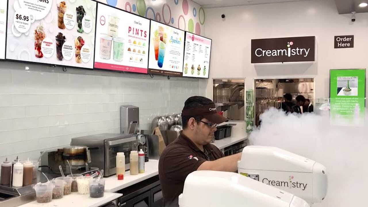 worker preparing a dish at ice cream shop
