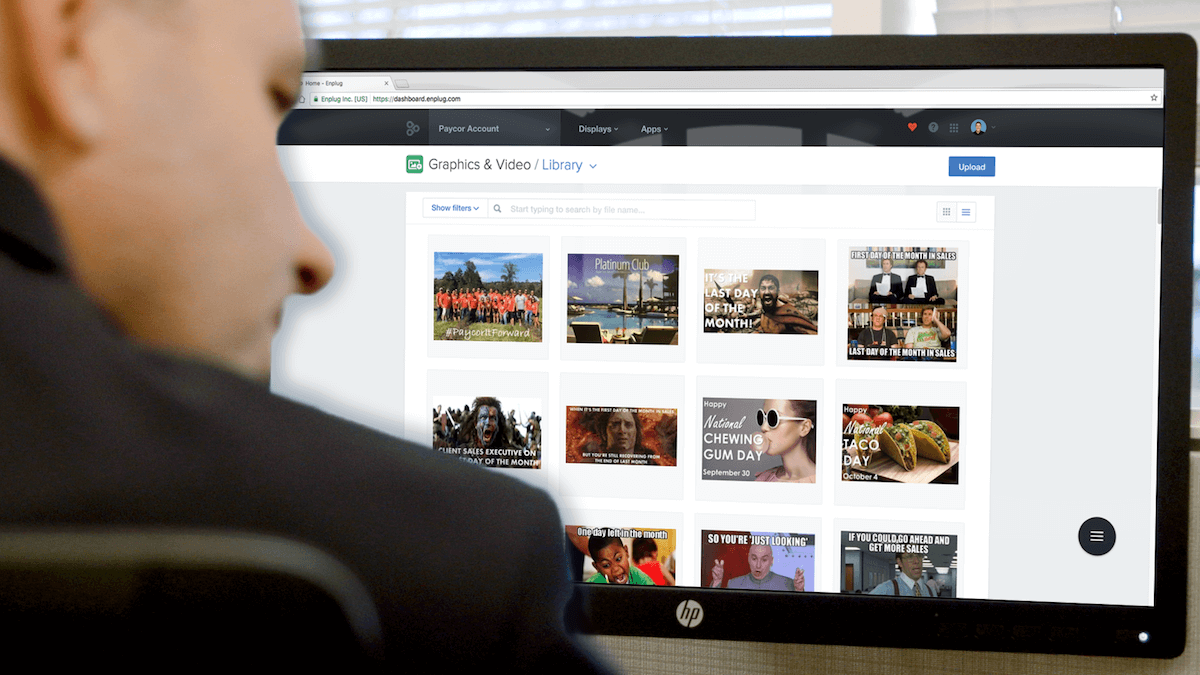 Brian Vass at Paycor using Enplug's digital signage content management dashboard in the digital workplace