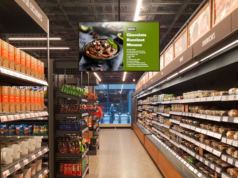 digital display hanging over grocery store aisle