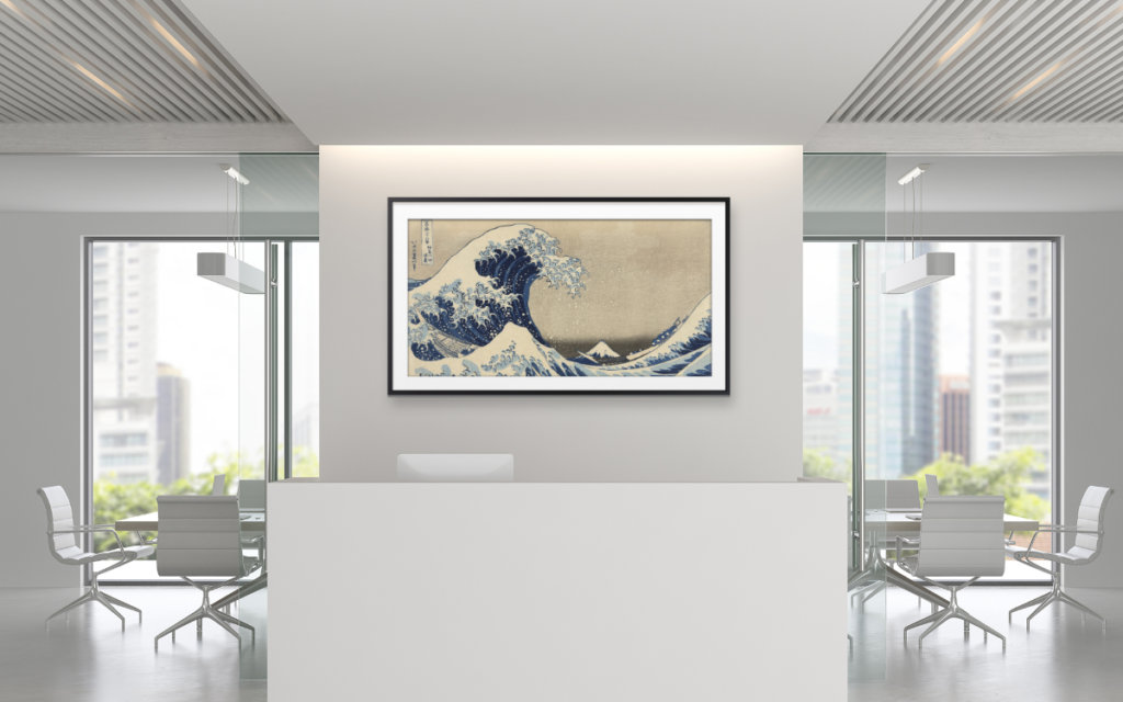artwork displayed on a tv screen behind a lobby desk