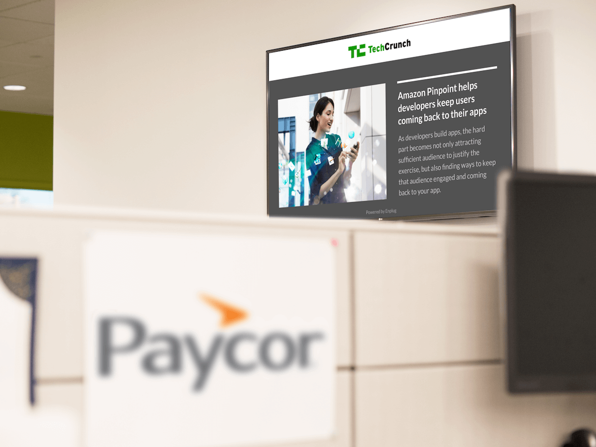 paycor logo in a lobby with a display on the wall