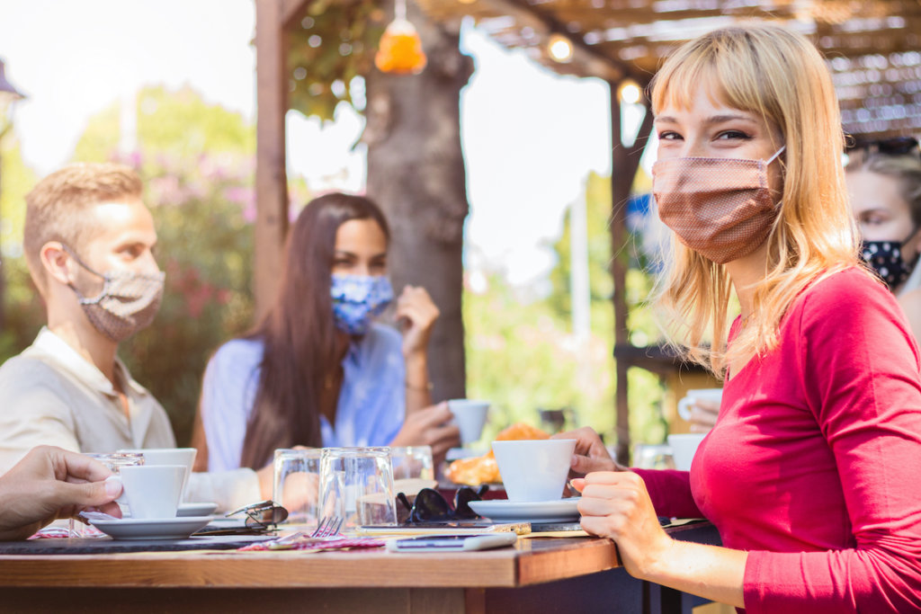 Masked customers in a restaurant reopening after COVID-19 shutdown
