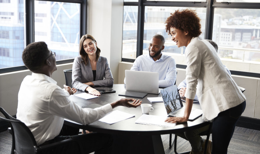 coworkers happily discussing at a rountable