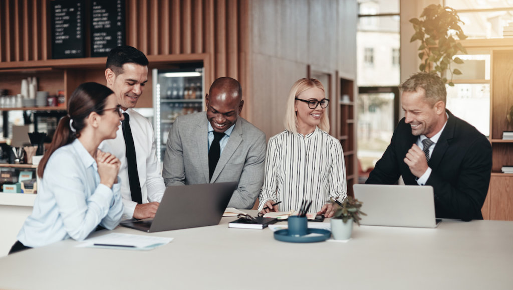 Group of businesspeople collaborating in corporate cafe