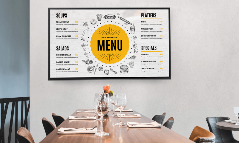 Digital menu display above a communal dining table in a retirement community