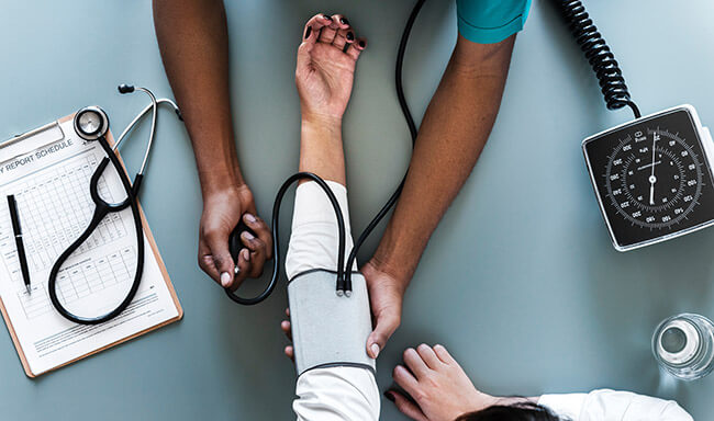 Doctor takes patient's blood pressure