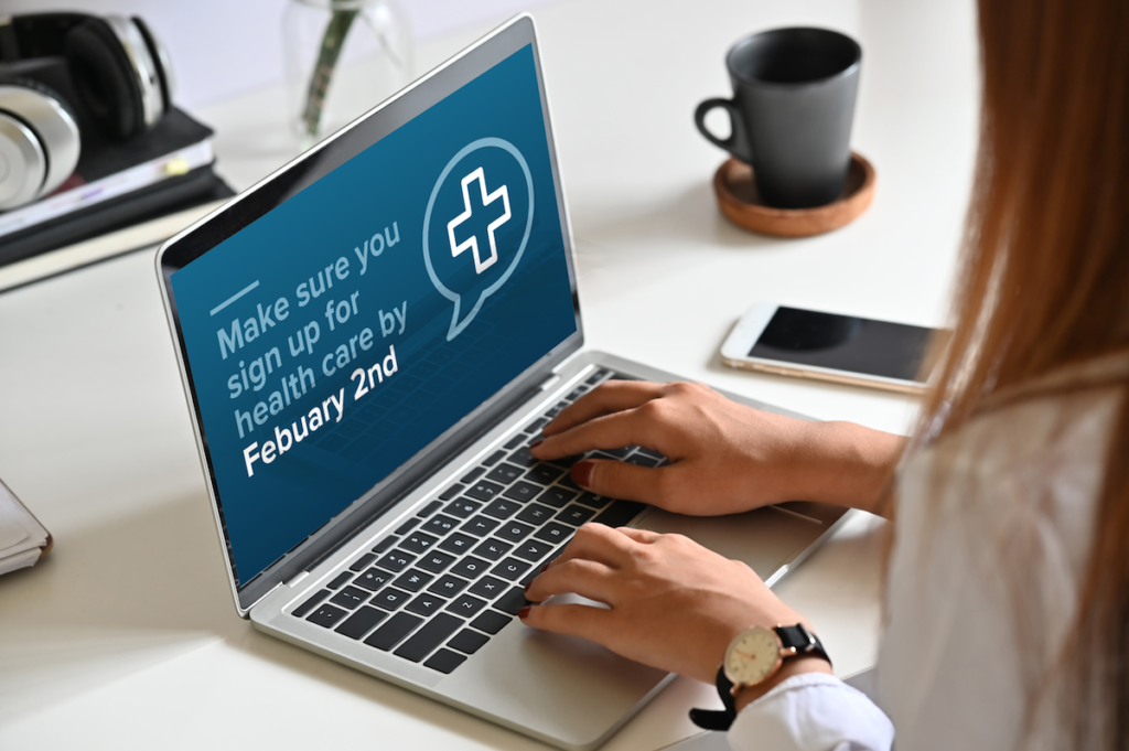 woman on laptop with a message reminding her to sign up for healthcare