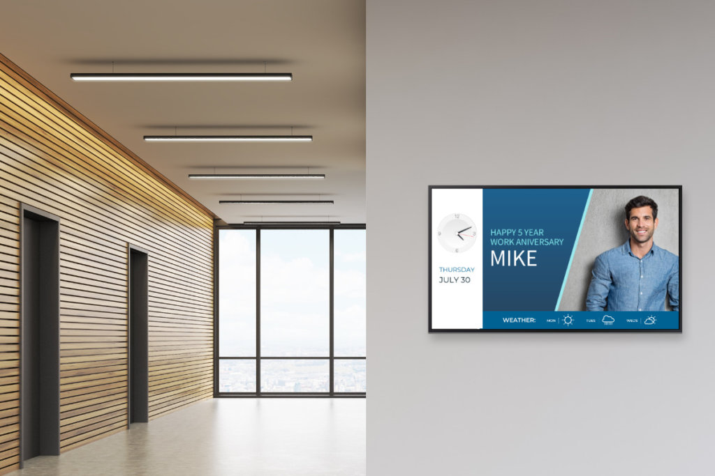 Employee recognition digital signage in an office hallway