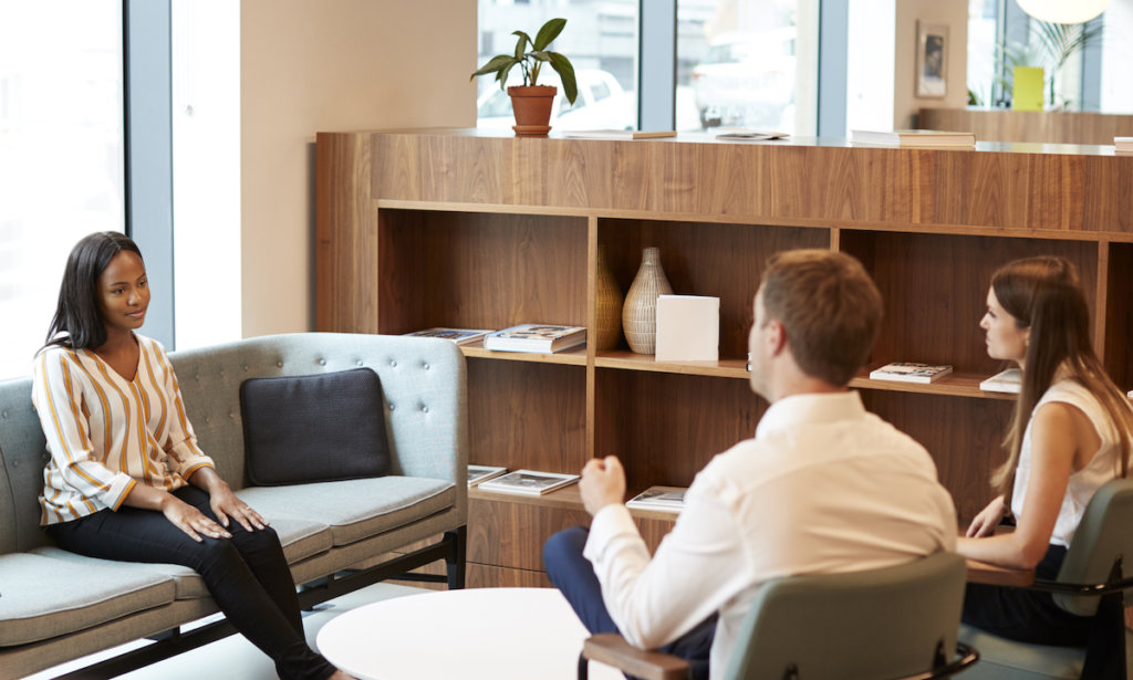 Two interviewers talking with a job candidate