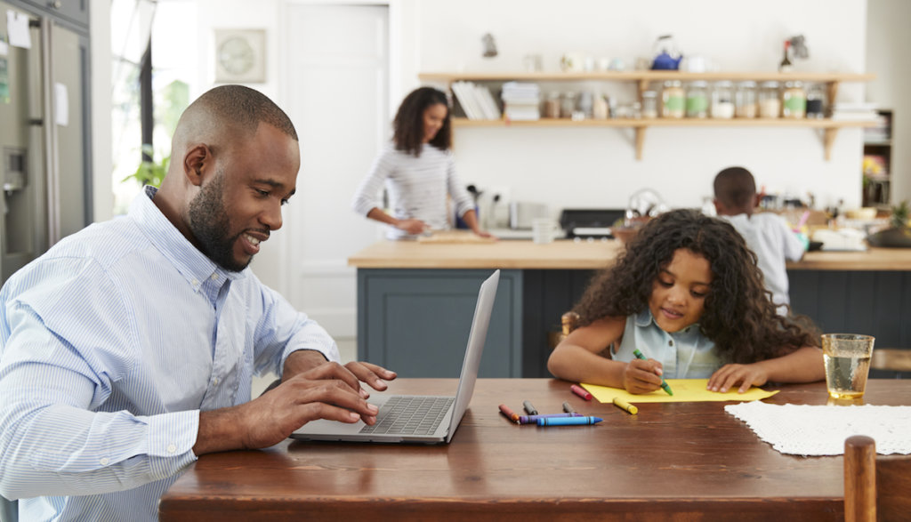 Businessman working from home with his family