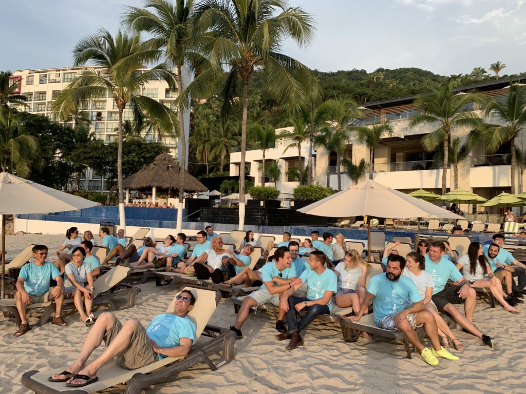 Enplug team on beach lounge chairs