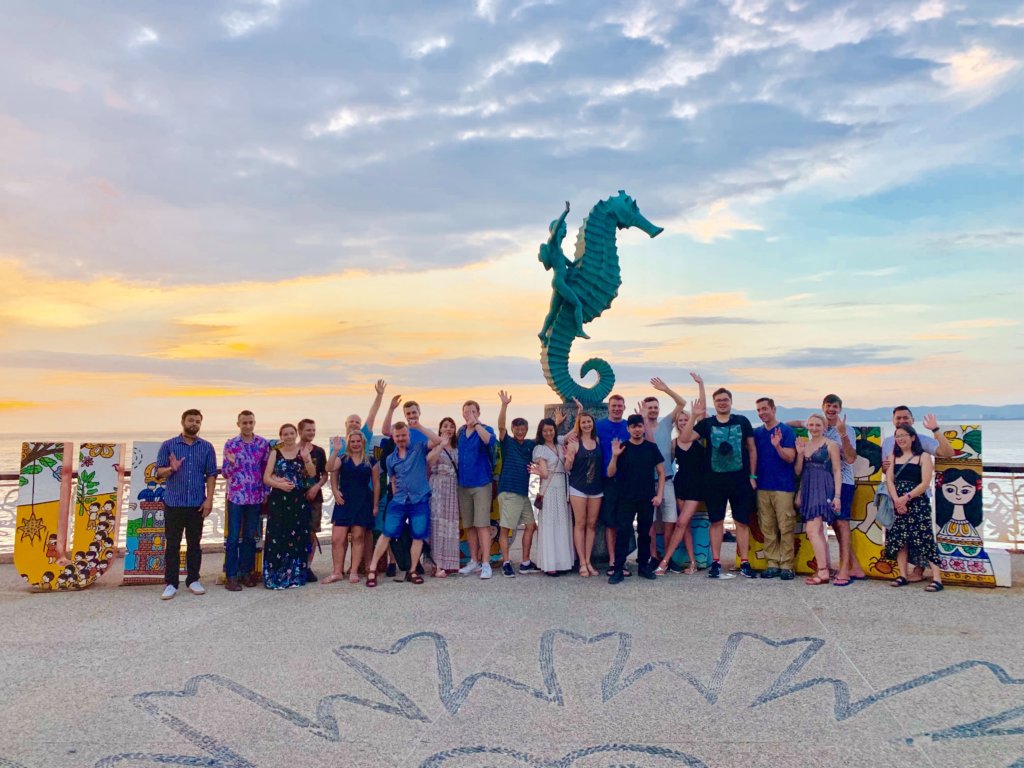 Enplug Team photo in front of seahorse statue in Puerto Vallarta, Mexico