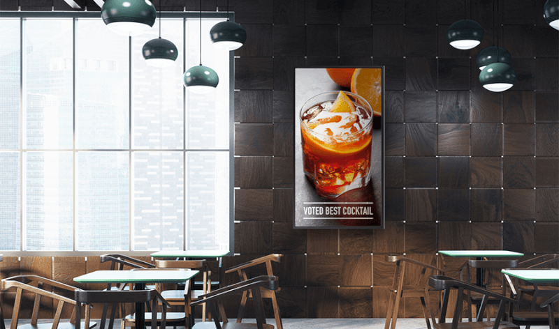 interior of restaurant with a vertical digital display over a table