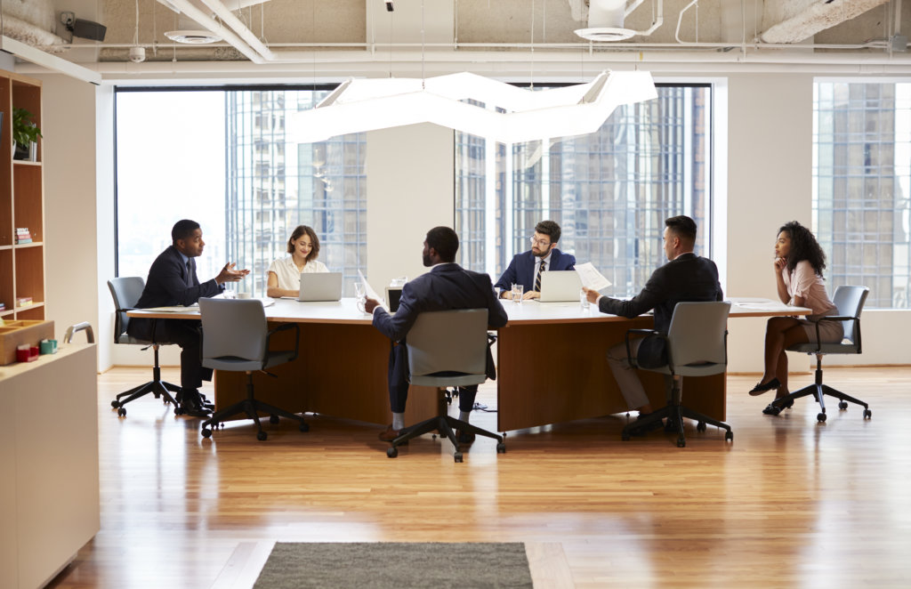 Business people in internal meeting around conference table