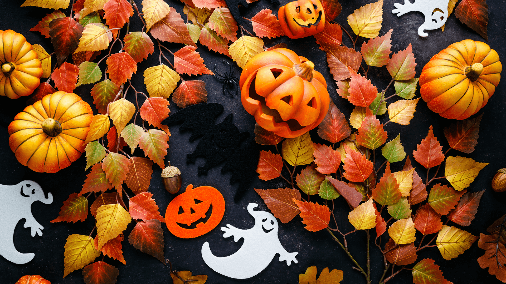 Halloween pumpkins, ghosts and fall leaves background