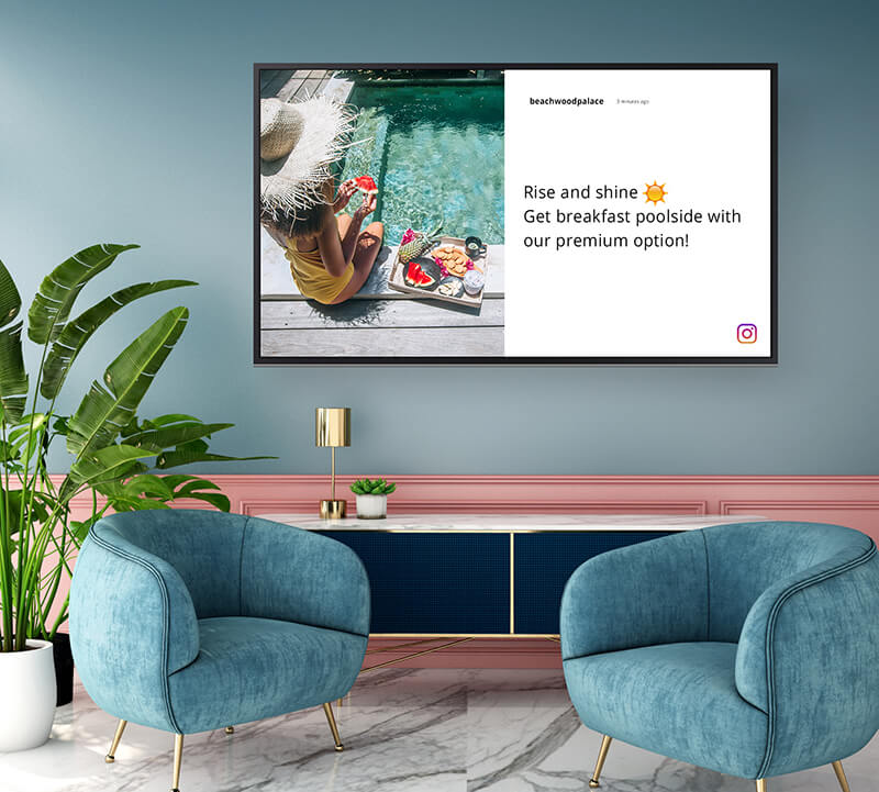 Digital signage displaying Instagram content in a modern luxury hotel lobby.