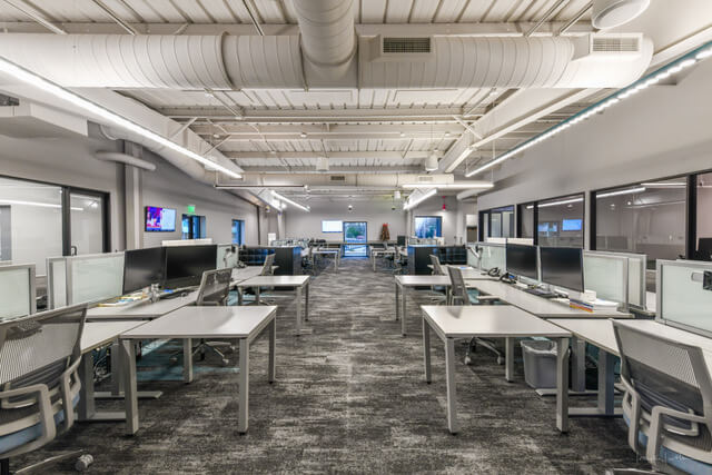 interior modern workplace with desks down a hall