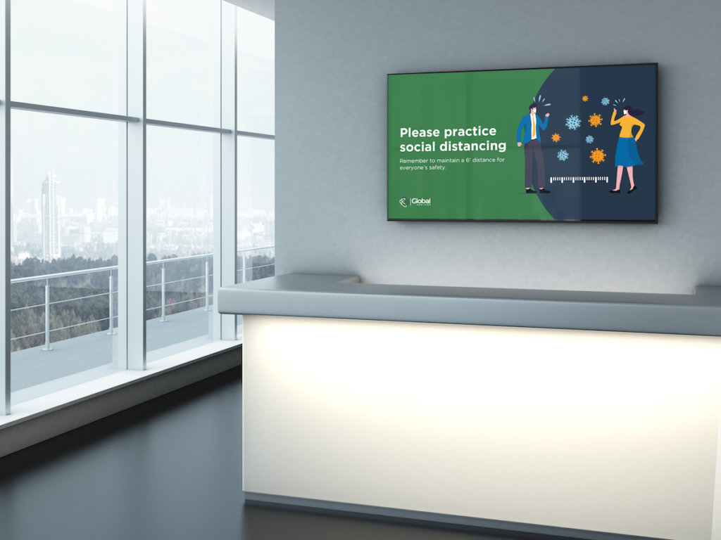 workplace lobby desk with a digital display hanging on the wall behind it