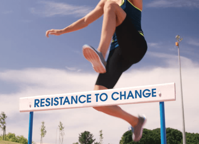 person hurdling with the words "resistance to change" on the hurdle