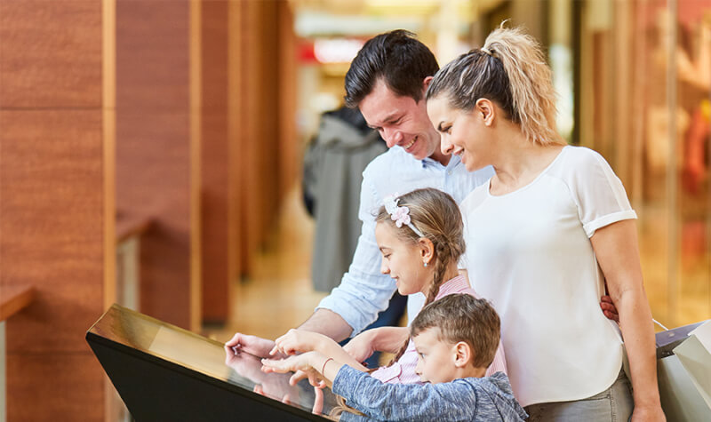 family using an interactive touchscreen display