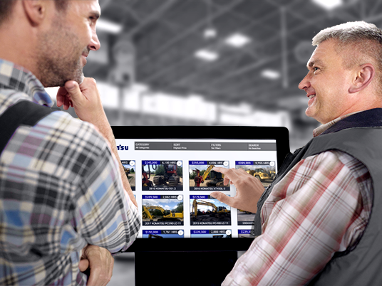 two men using a kiosk at a store