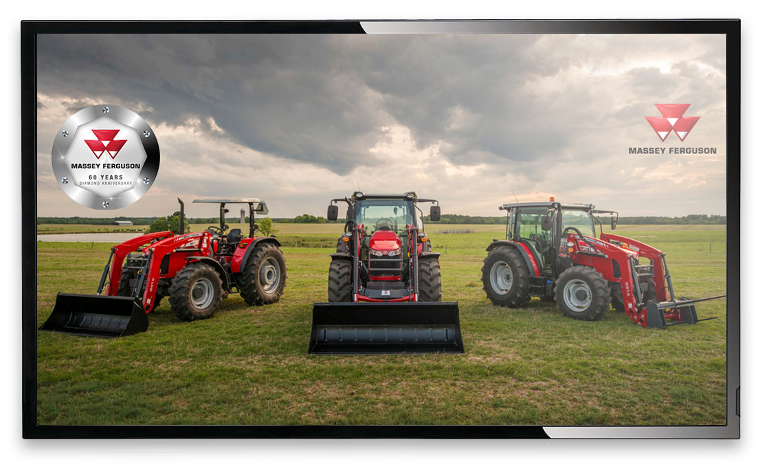 three tractors out on a lawn