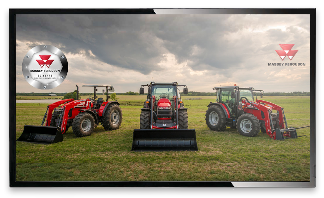 three tractors out on a lawn