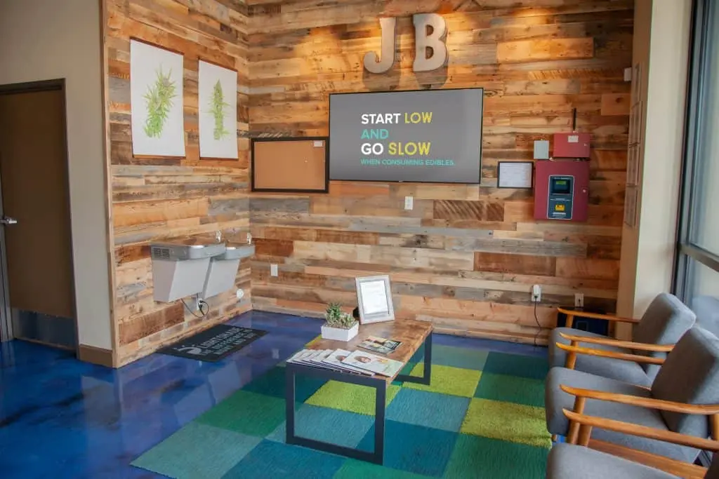 lobby of a dispensary with a digital sign on the wall