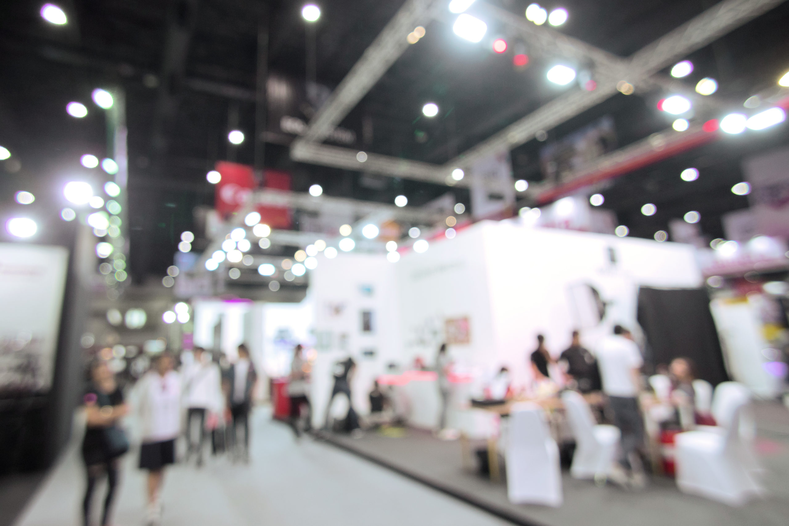 Blurred image of people walking around a trade show