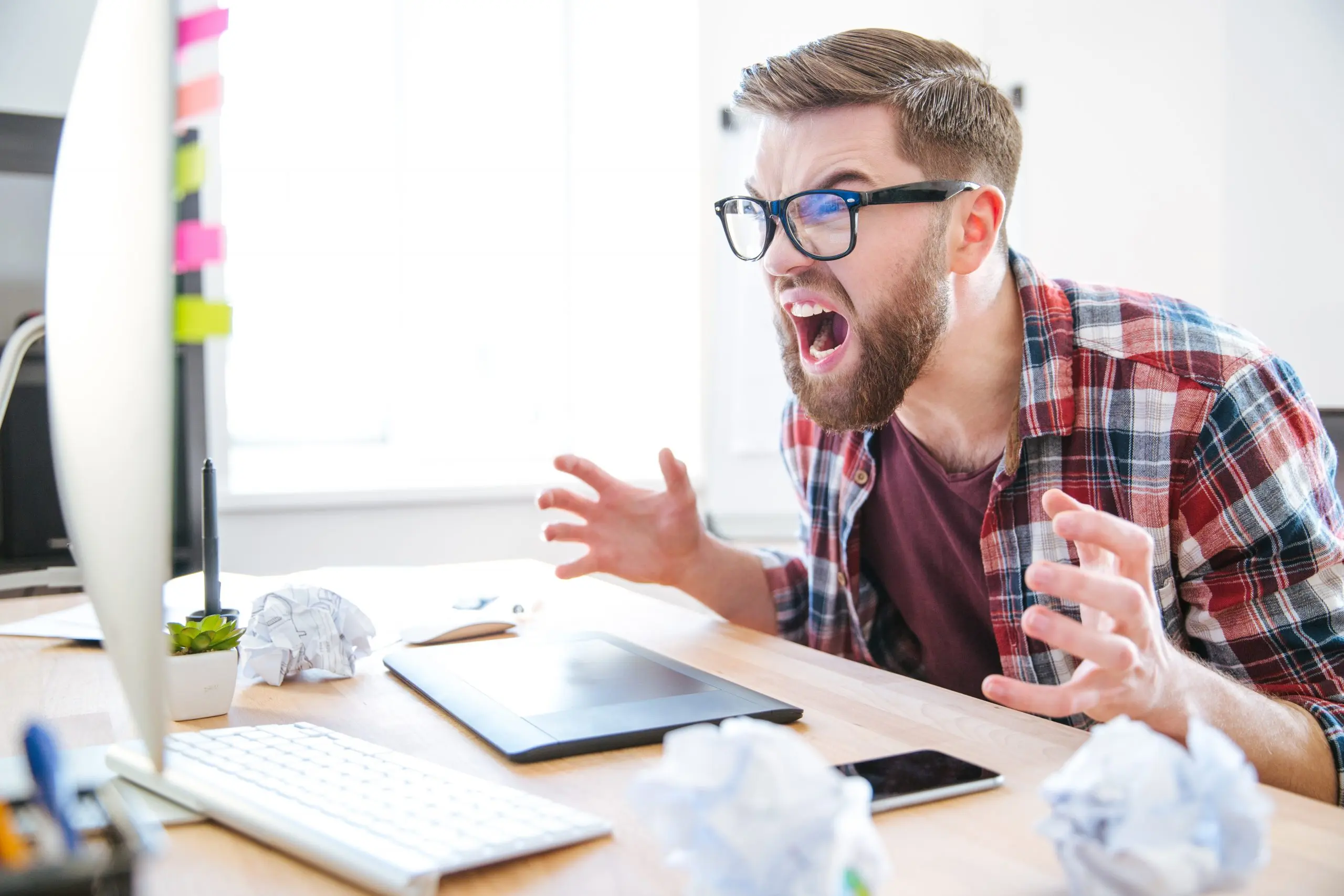 guy with hands up yelling at his computer