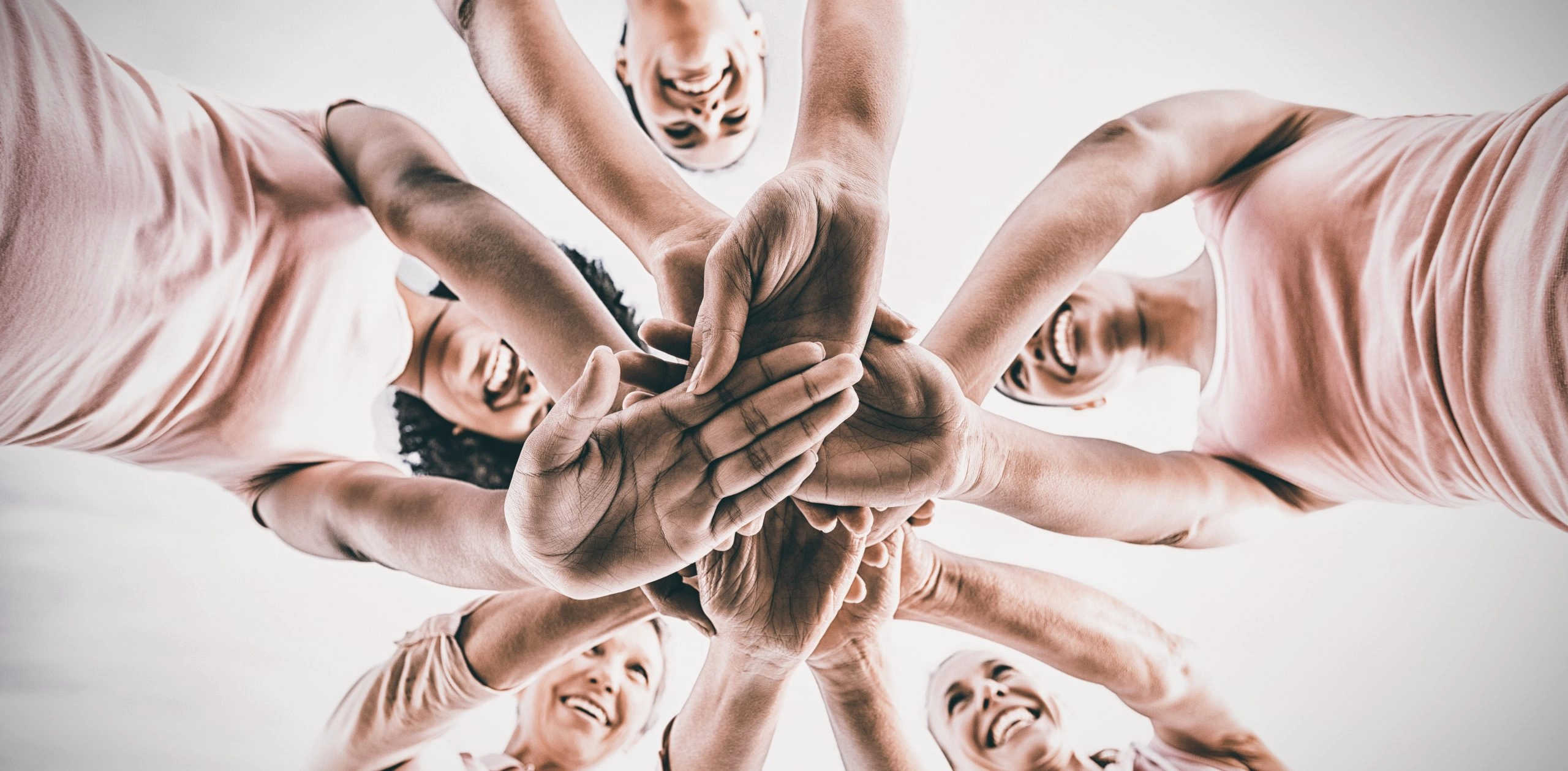 woman in a circle with the hands gathered in the middle