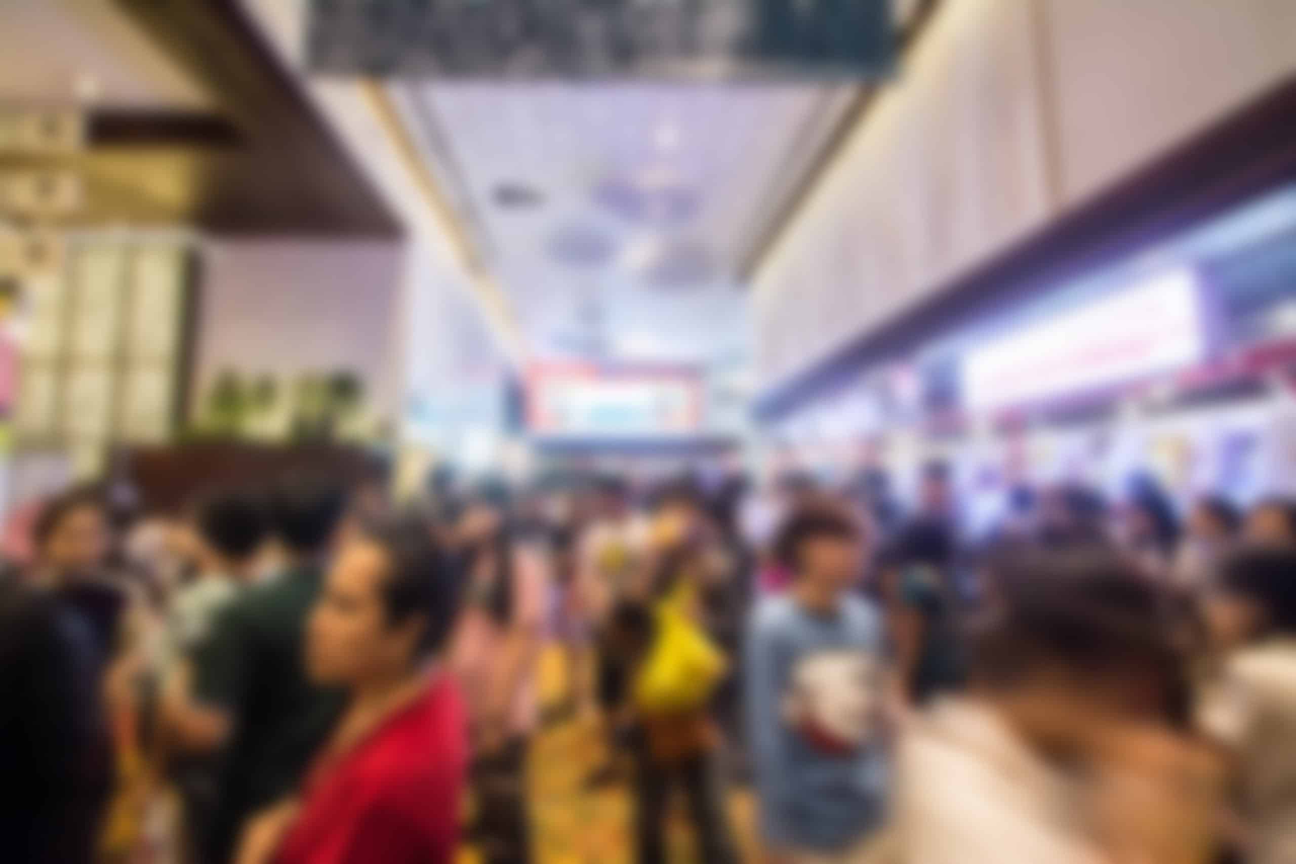 Photo of a busy convention hall blurred